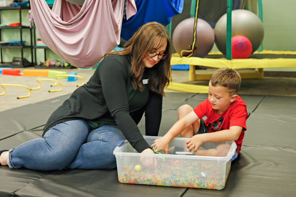 any activity that stimulates a child's senses, such as sight, touch, hearing, smell, or taste